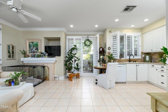 kitchen featuring visible vents, white dishwasher, backsplash, and light tile patterned floors