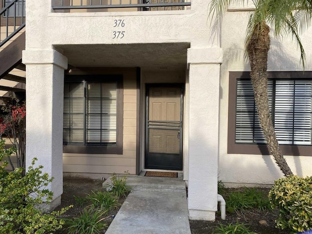 doorway to property with stucco siding