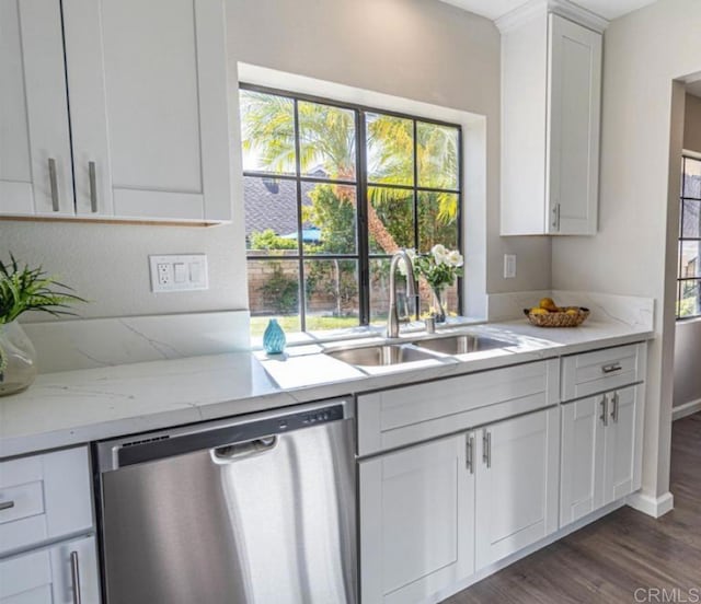 kitchen with dishwasher, white cabinets, plenty of natural light, and a sink