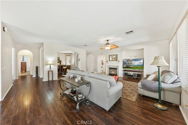 28183 Rocky Cove Dr, Menifee, CA 92585 - living area featuring arched walkways, ceiling fan, wood finished floors, and a fireplace