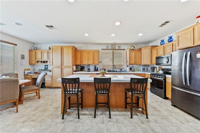 28183 Rocky Cove Dr, Menifee, CA 92585 - kitchen with stainless steel appliances, a kitchen island, light countertops, healthy amount of natural light, and recessed lighting