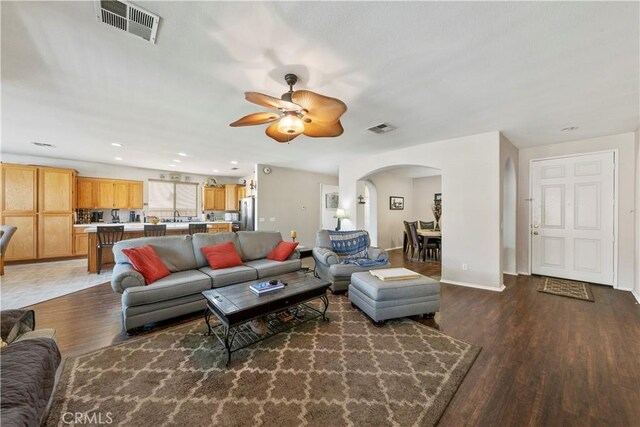 28183 Rocky Cove Dr, Menifee, CA 92585 - living room featuring arched walkways, wood finished floors, a ceiling fan, and recessed lighting