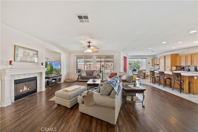 28183 Rocky Cove Dr, Menifee, CA 92585 - living room featuring dark wood-style floors, ceiling fan, a tile fireplace, and recessed lighting