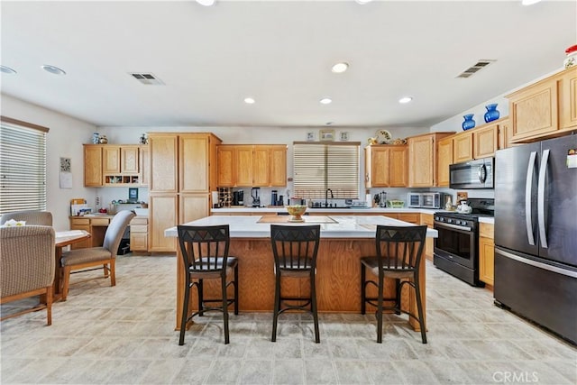 28183 Rocky Cove Dr, Menifee, CA 92585 - kitchen with appliances with stainless steel finishes, a kitchen island, light countertops, healthy amount of natural light, and recessed lighting