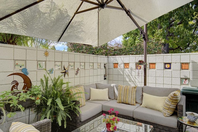 view of patio / terrace with outdoor lounge area and fence