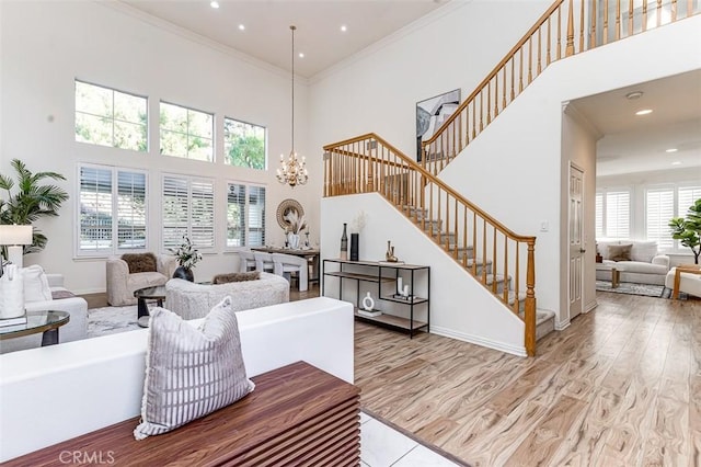 2768 Somerset Pl, Rowland Heights, CA 91748 - living area with a towering ceiling, stairs, a chandelier, ornamental molding, and recessed lighting