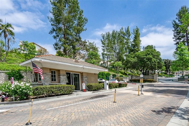 2768 Somerset Pl, Rowland Heights, CA 91748 - view of front of property with a tile roof, a gate, fence, stone siding, and stucco siding
