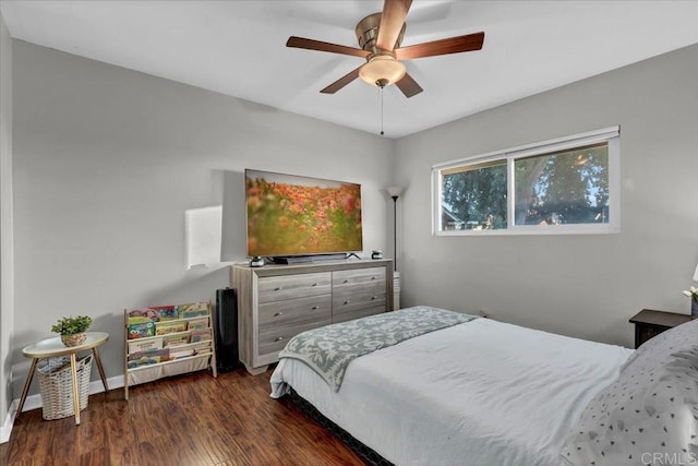 bedroom featuring baseboards, a ceiling fan, and dark wood-style flooring