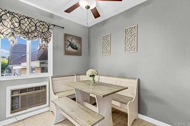 dining space with baseboards, ceiling fan, and tile patterned flooring