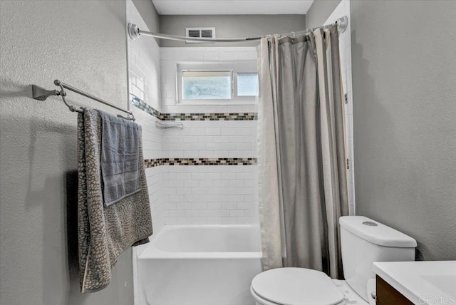 bathroom featuring visible vents, toilet, shower / tub combo, a textured wall, and vanity