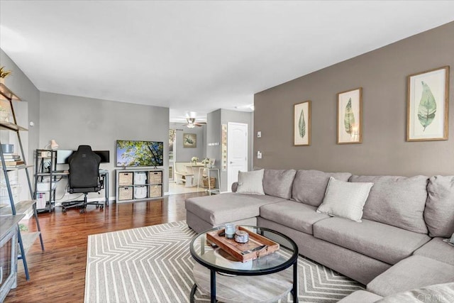 living room featuring ceiling fan and wood finished floors