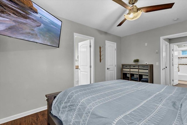 bedroom featuring a ceiling fan, wood finished floors, baseboards, and ensuite bathroom