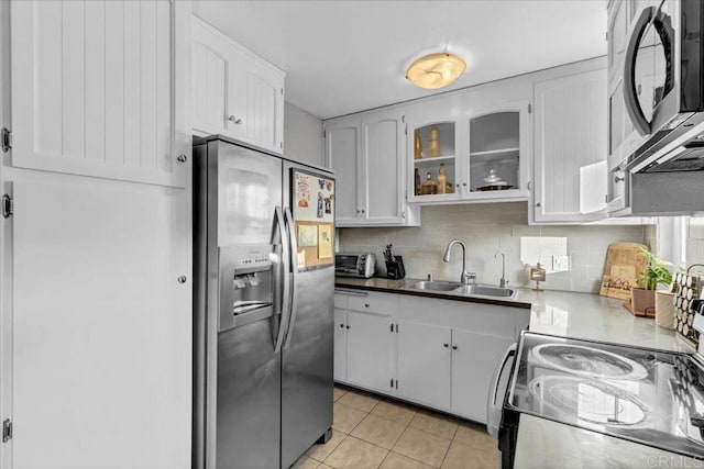 kitchen featuring a sink, appliances with stainless steel finishes, and white cabinets