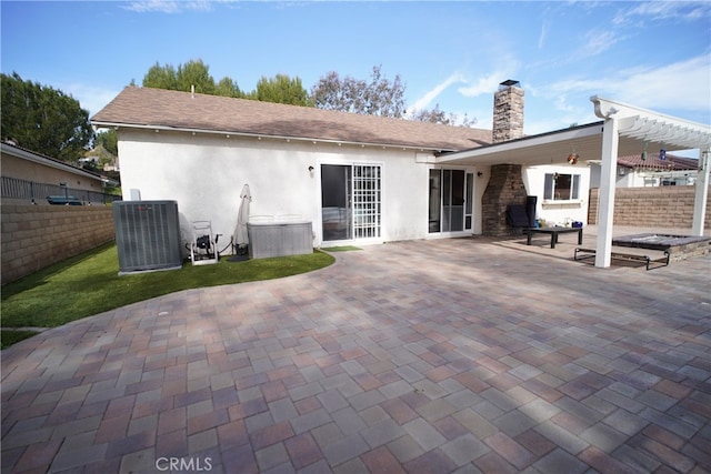 back of property featuring cooling unit, a patio, fence, and a chimney