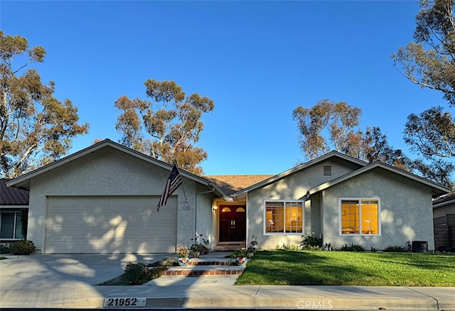 single story home featuring a garage, stucco siding, and driveway