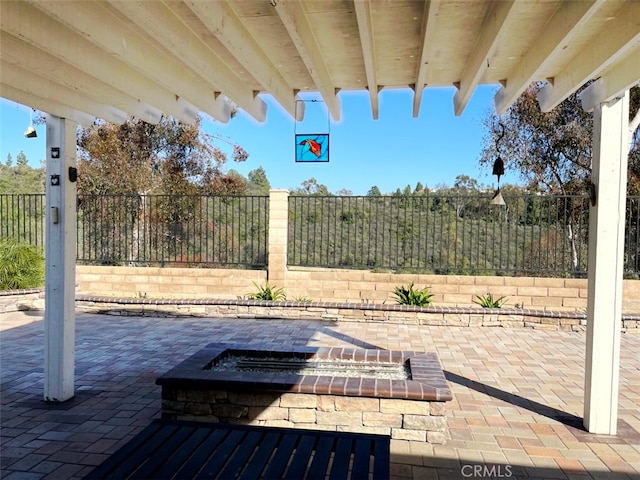 view of patio with a fenced backyard and an outdoor fire pit