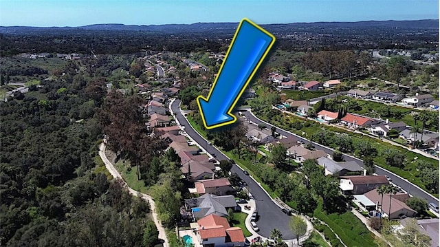 bird's eye view with a wooded view and a residential view