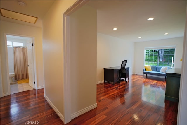 hall featuring recessed lighting, baseboards, and dark wood-type flooring