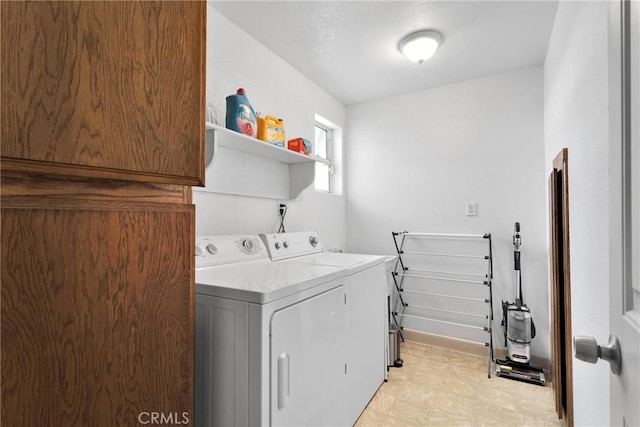 clothes washing area featuring laundry area, independent washer and dryer, and light floors