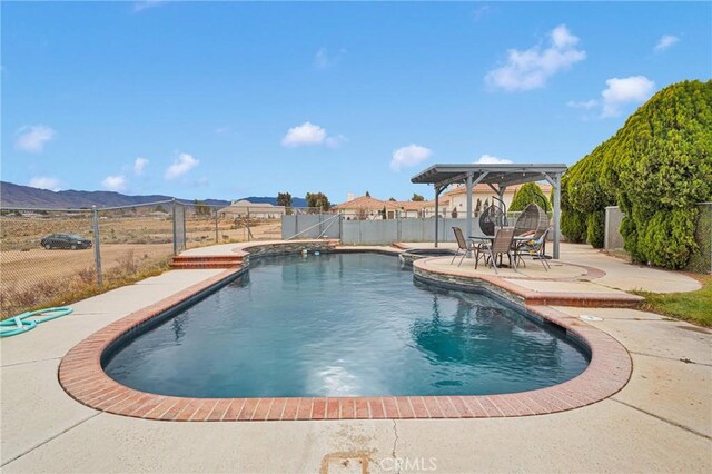 view of swimming pool featuring a mountain view, a patio, a fenced in pool, and a fenced backyard