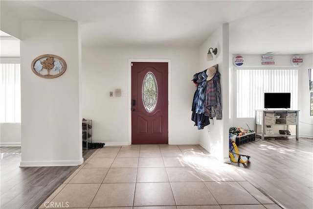 entrance foyer with tile patterned flooring and baseboards