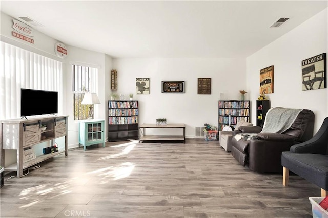 living area featuring wood finished floors and visible vents