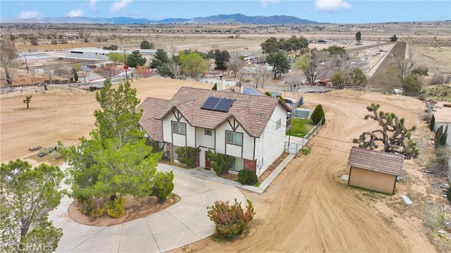 birds eye view of property featuring a mountain view and a desert view