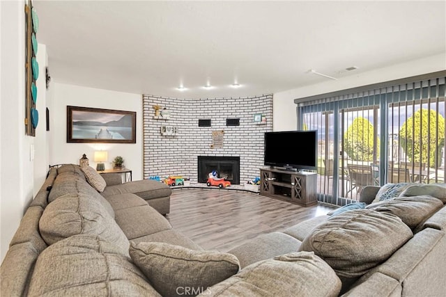 living area featuring a fireplace and wood finished floors