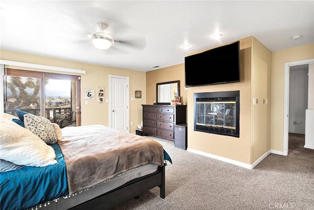 bedroom featuring a ceiling fan, carpet, a multi sided fireplace, and baseboards