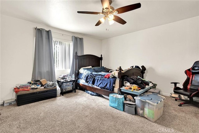 bedroom with carpet flooring, baseboards, and a ceiling fan