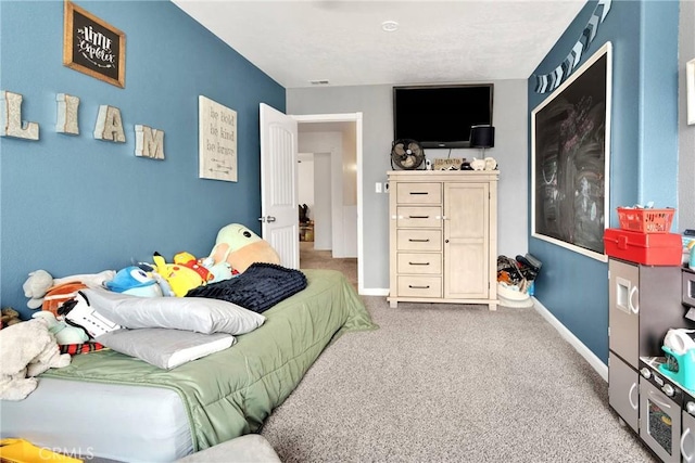 bedroom featuring baseboards, carpet floors, and visible vents