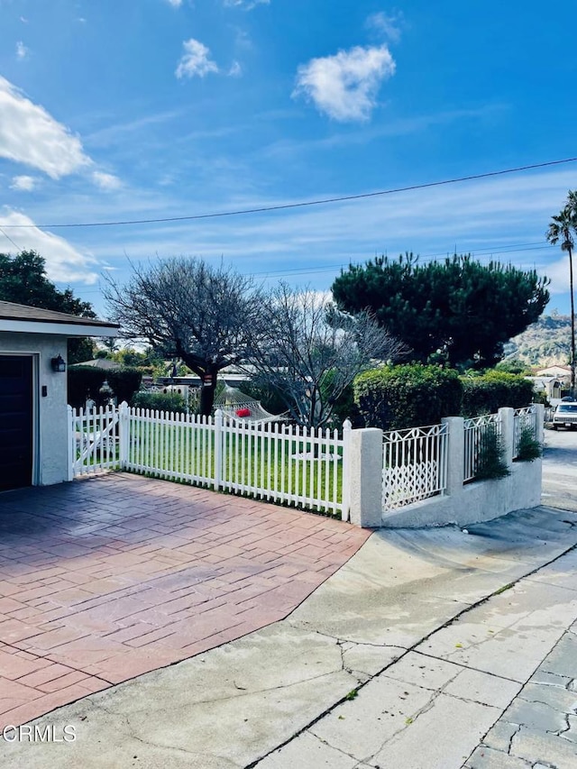 wooden terrace featuring a fenced front yard