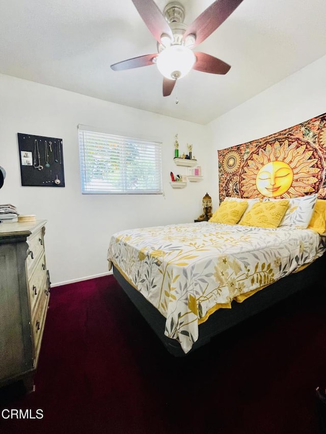 bedroom with dark carpet, baseboards, and a ceiling fan