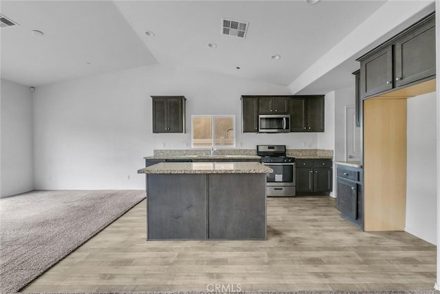 222 Garden Air Ct, Calimesa, CA 92320 - kitchen featuring light wood finished floors, visible vents, a center island, open floor plan, and stainless steel appliances