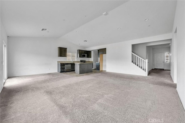 222 Garden Air Ct, Calimesa, CA 92320 - unfurnished living room with light carpet, visible vents, stairs, and vaulted ceiling