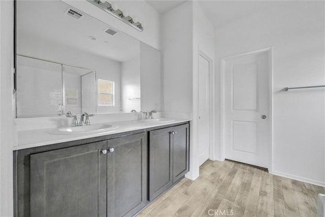 222 Garden Air Ct, Calimesa, CA 92320 - bathroom with a sink, visible vents, wood finished floors, and double vanity