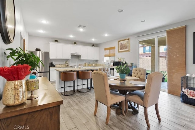 dining area featuring recessed lighting, visible vents, and light wood-type flooring