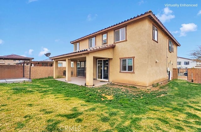 back of property featuring stucco siding, a patio, and fence private yard