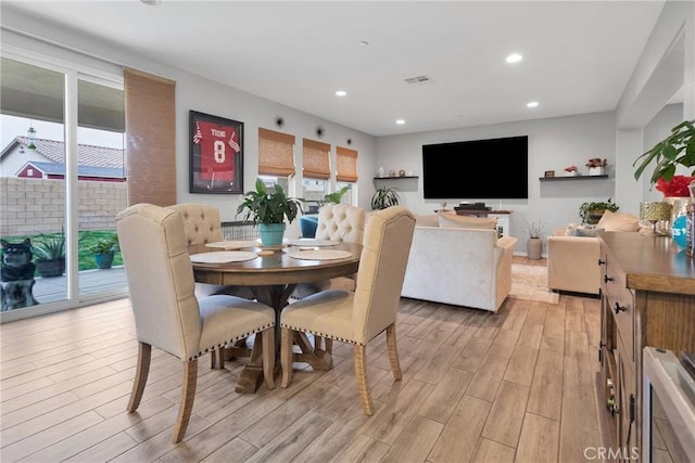 dining room with recessed lighting, light wood-style floors, and visible vents