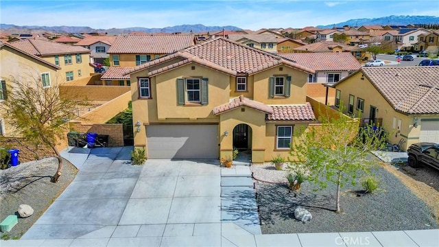 mediterranean / spanish home featuring a residential view, stucco siding, an attached garage, and a tile roof