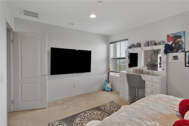 bedroom featuring light carpet and visible vents