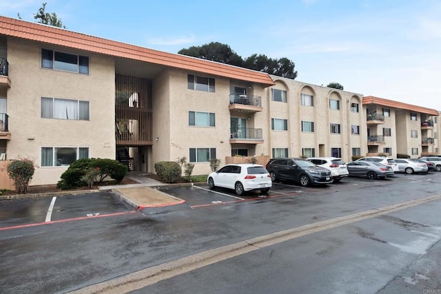 view of property featuring uncovered parking