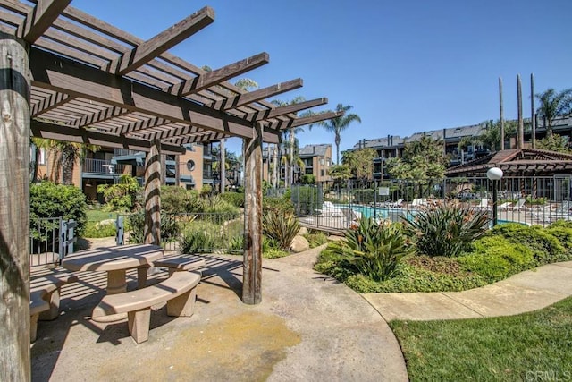 view of patio with a pergola and fence