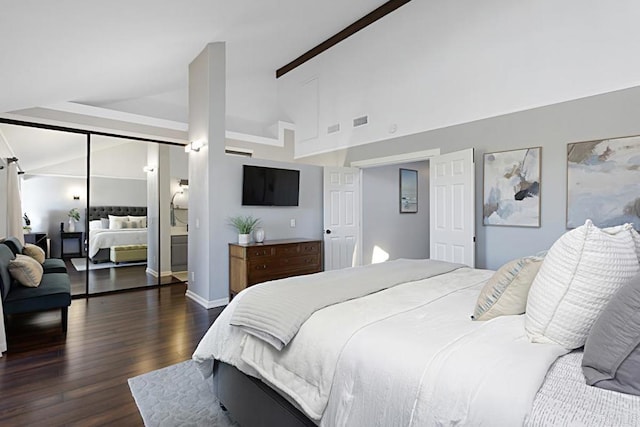 bedroom with dark wood finished floors, visible vents, high vaulted ceiling, and baseboards