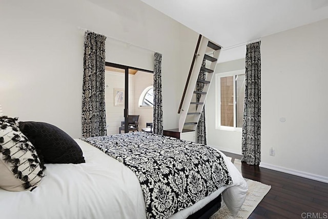 bedroom featuring baseboards and wood finished floors