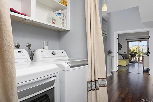 washroom with dark wood-style flooring, laundry area, and washing machine and clothes dryer