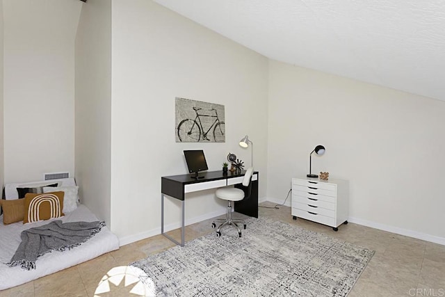 office featuring tile patterned flooring, lofted ceiling, and baseboards