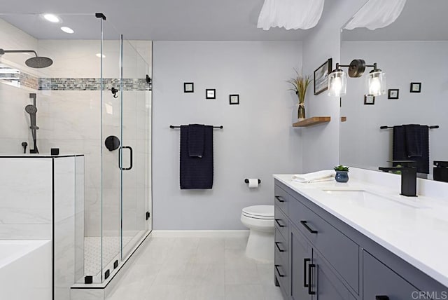 bathroom with toilet, a stall shower, baseboards, a bathtub, and vanity