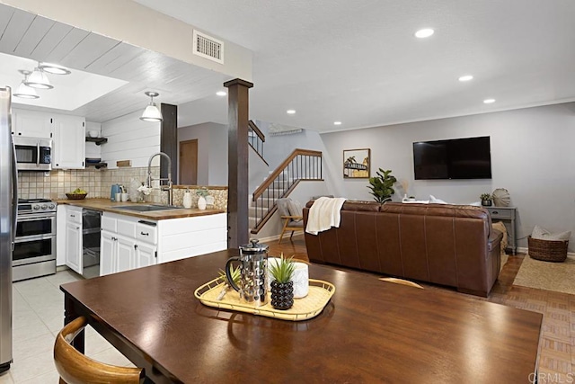 dining space with visible vents, recessed lighting, stairway, light tile patterned floors, and baseboards