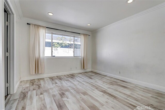 unfurnished room featuring crown molding, recessed lighting, wood finished floors, and baseboards